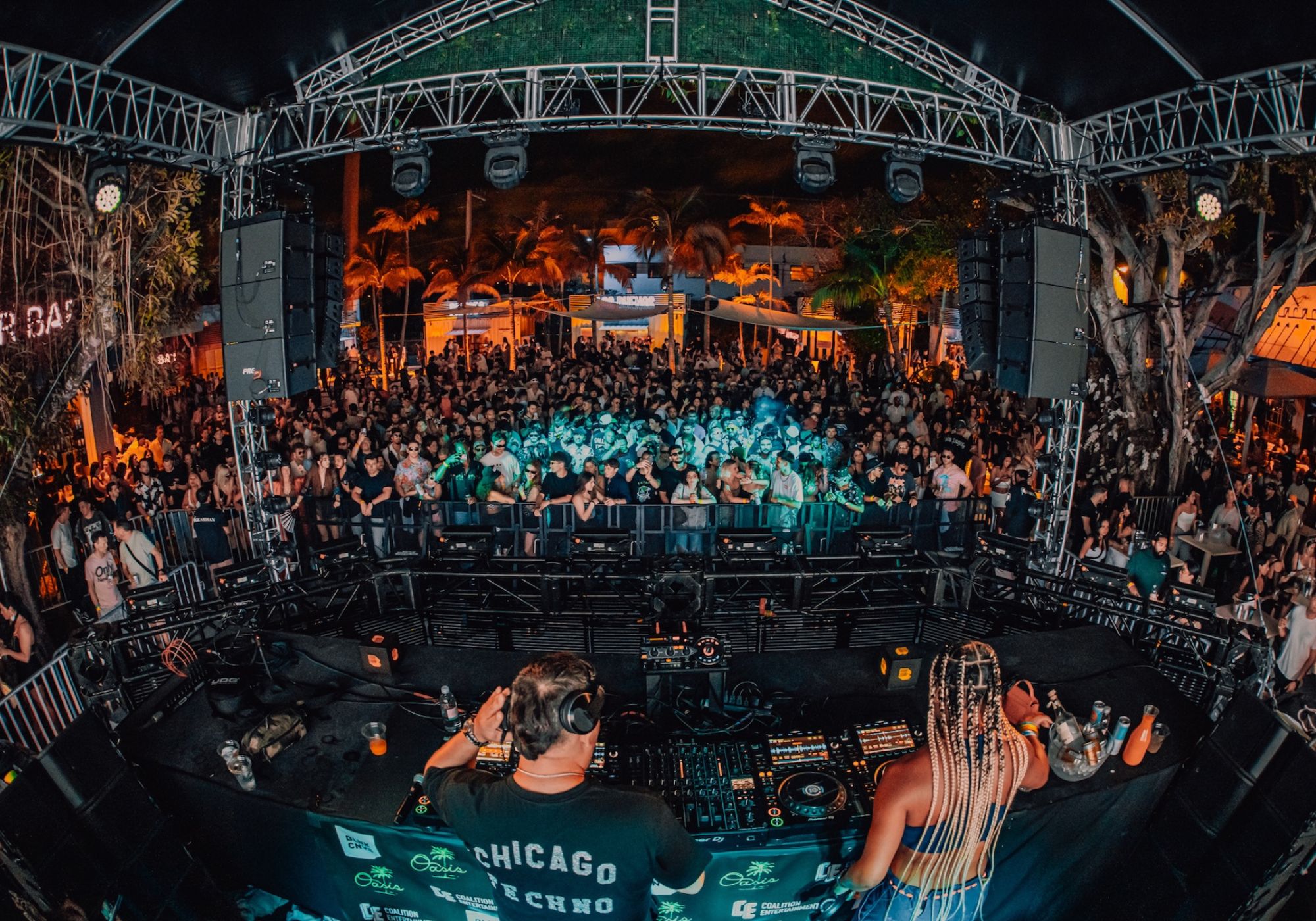 Photo of a stage at a venue full of people