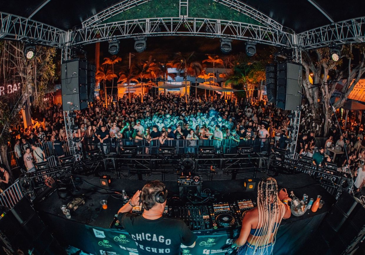 Photo of a stage at a venue full of people