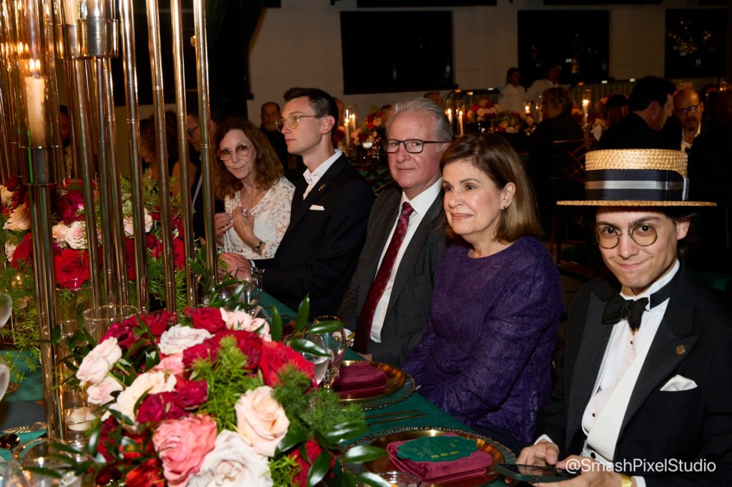Dariel Gonzalez sat next to Coral Gables City Manager Peter Iglesias and his wife at the Chamber of Commerce gala.