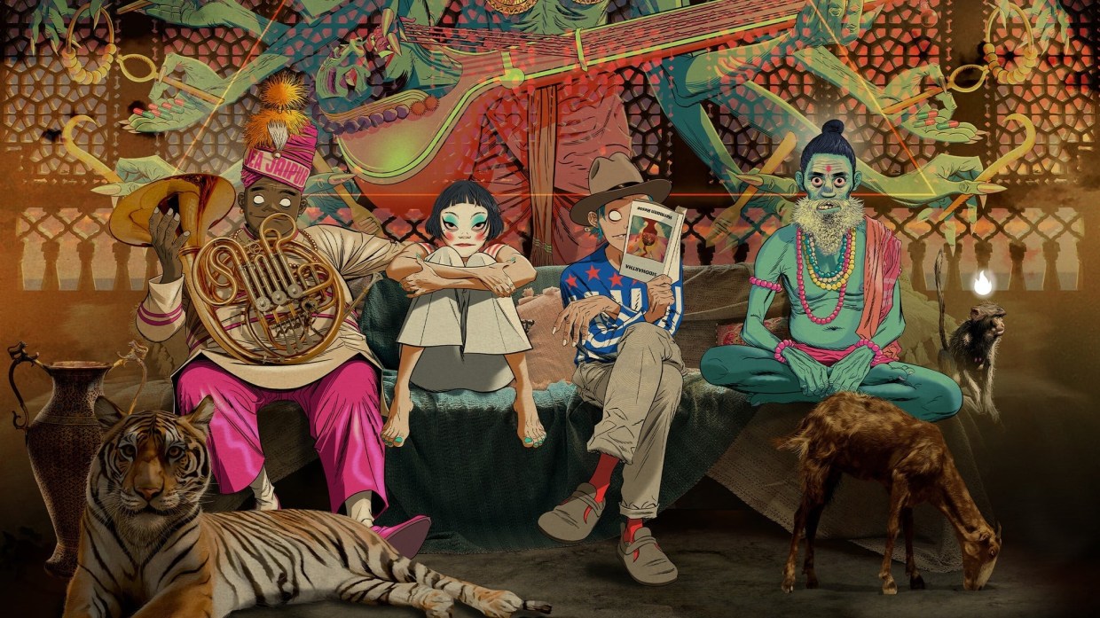The animated cast of the Gorillaz virtual band sit on a couch. Russel has a French horn and is wearing a feathered cap with a band that says "Jaipur" on it. Noodle, to his right, has on heavy white, blue and red makeup. 2D is reading something, and Murdoc, sitting cross-legged, has a large beard, prayer beads, and a bindi. A semi-translucent Hindu deity stands behind the couch, only visible from chest to waist.