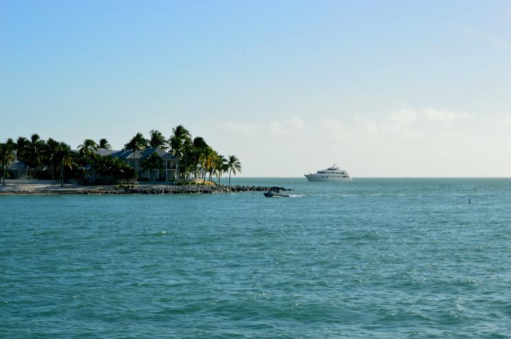 photo of a cruise ship approaching an island surrounded by ocean