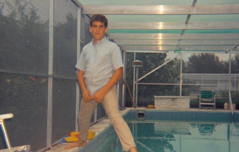 grainy photo of a young boy standing over a pool in the '70s
