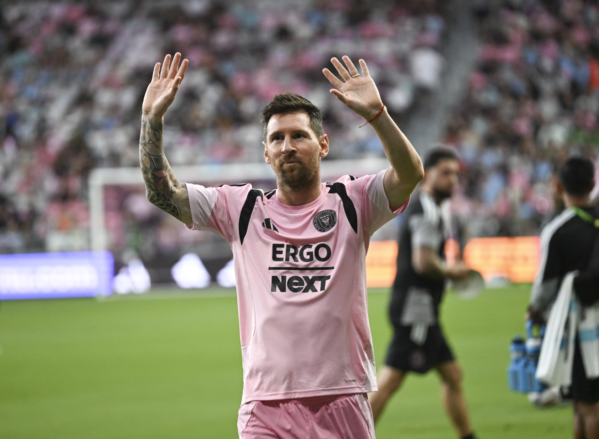 photo of Lionel Messi waving at fans from the field of Nu Stadium