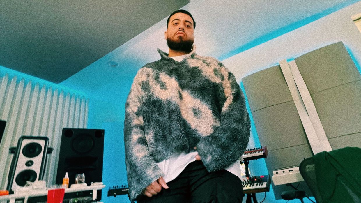 Photo of a man standing in a small studio.