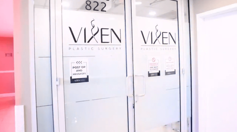 A screenshot from a YouTube video of doors to a plastic surgery clinic that read "VIXEN"