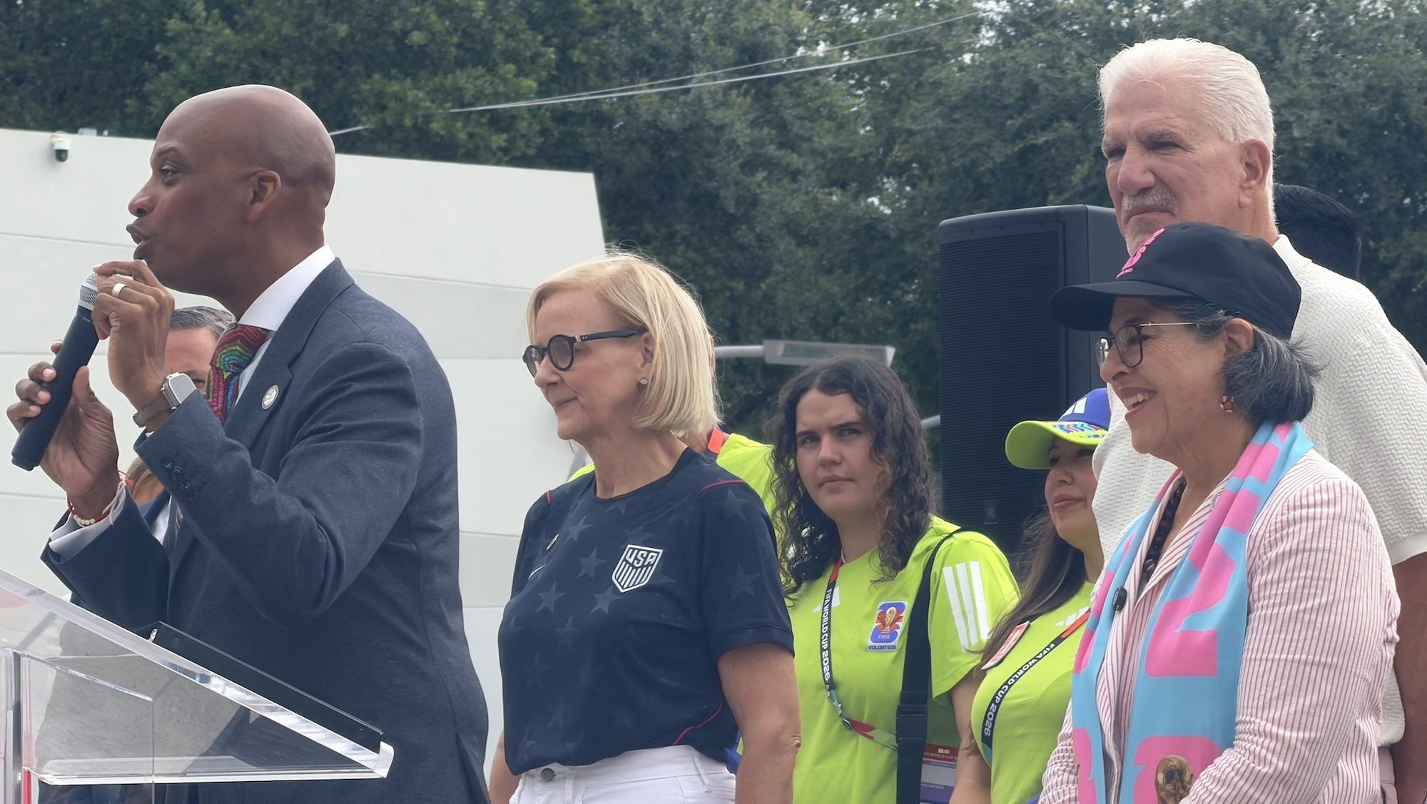 photo of Commissioner Oliver G. Gilbert speaking at a microphone next to Miami mayors Eileen Higgins and Daniella Levine Cava