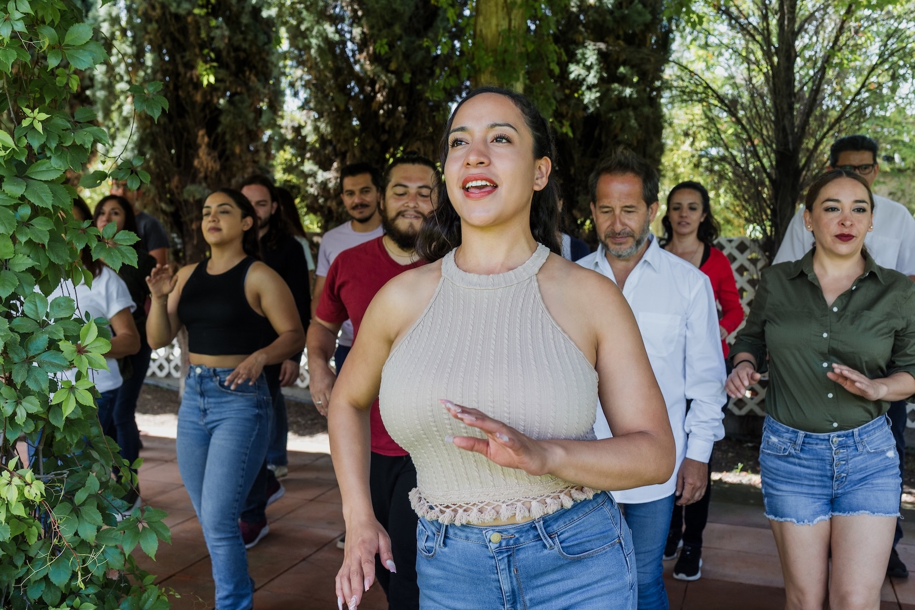 Group of latino friends enjoying a salsa dancing class outdoors in Mexico Latin America. Hispanic people moving to the rhythm and having a fun together