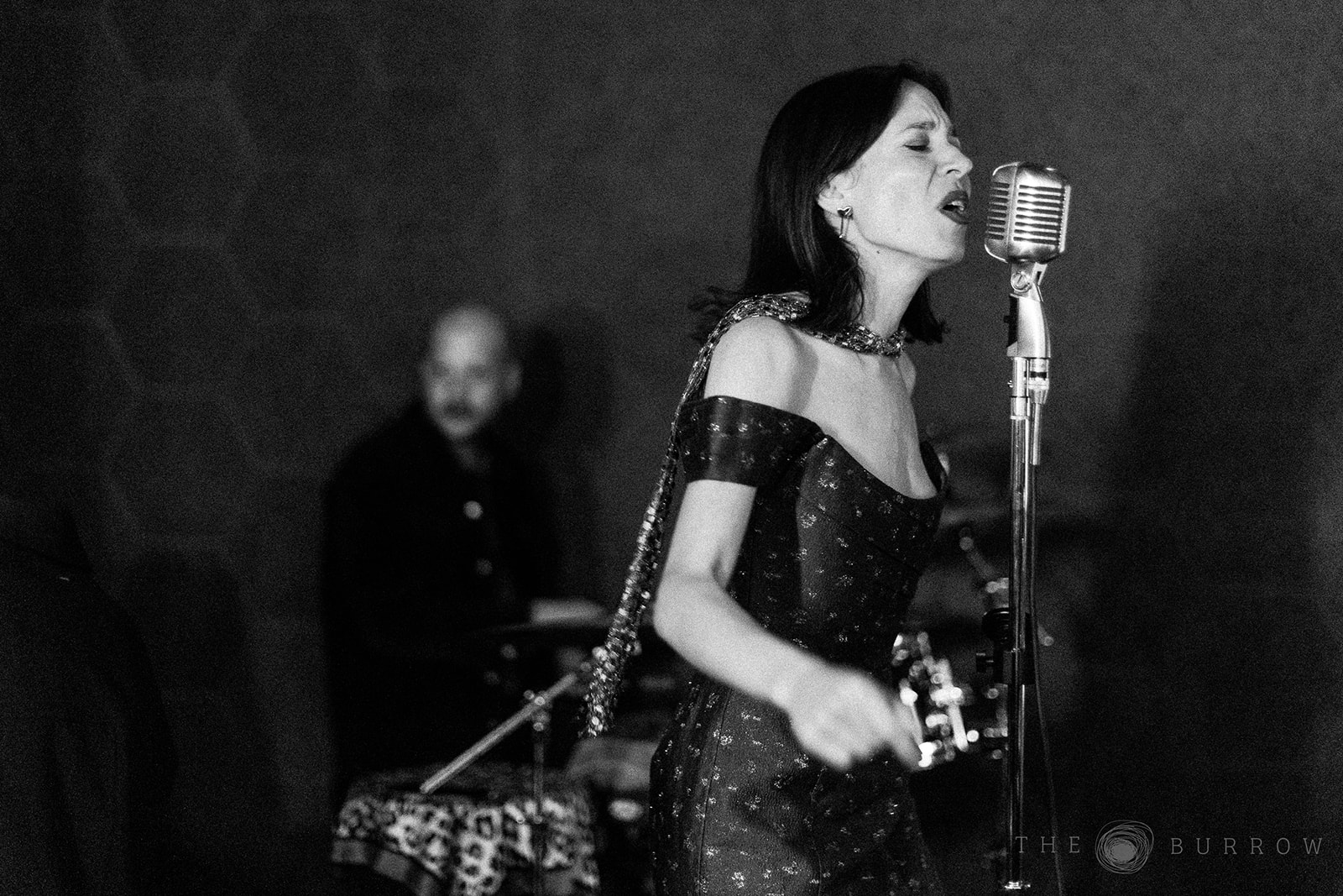 Photo of a jazz singer performing wearing a dress at the Burrow in Miami.