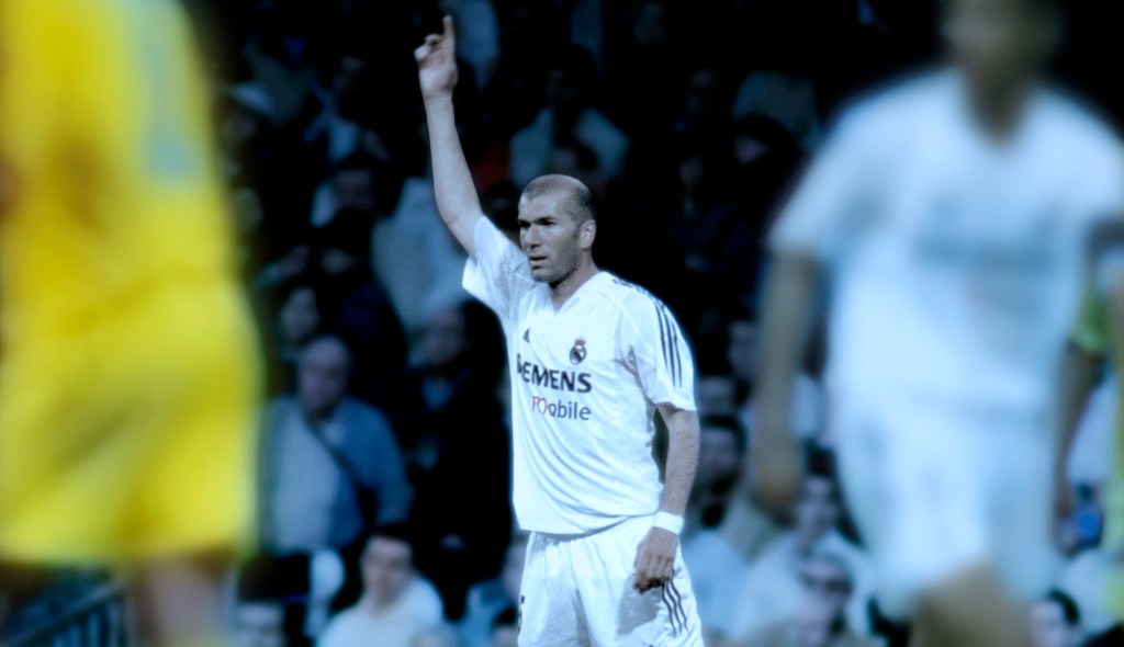 photo of Zinedine Zidane holding up his hand on the soccer field