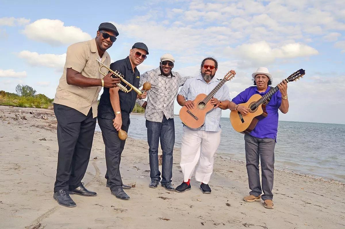 Photo of five Cuban musicians by the beach in Miami