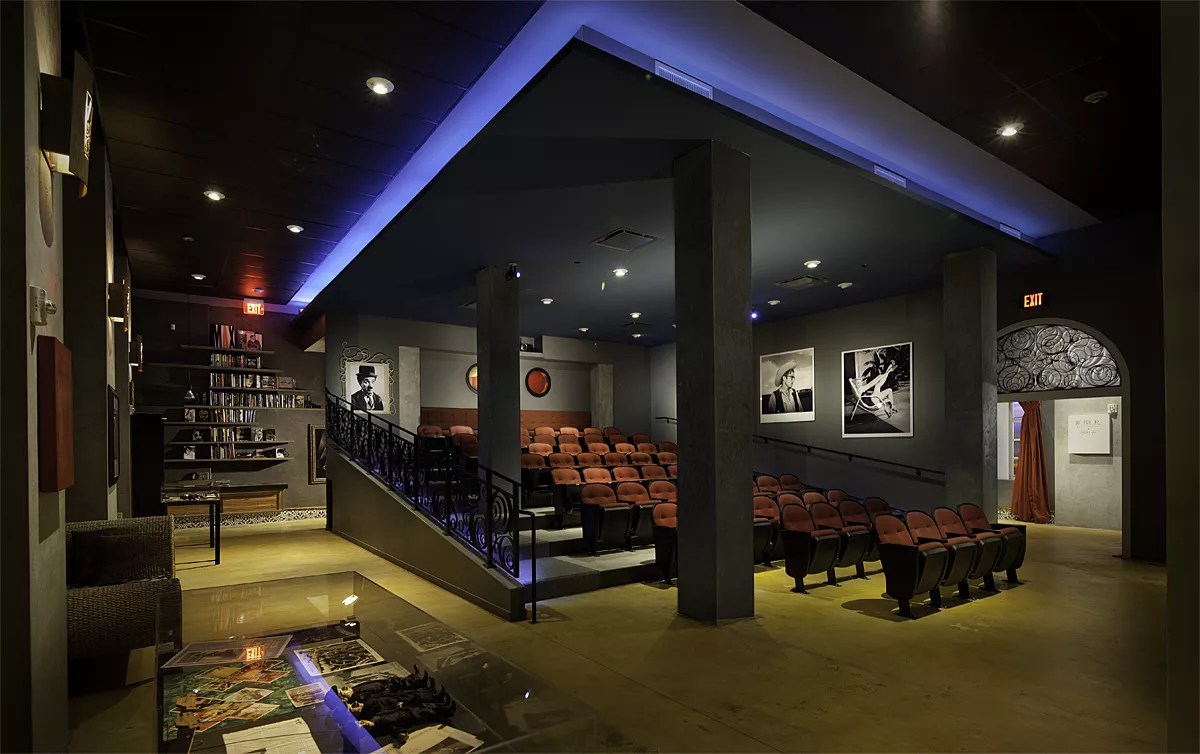 a small arthouse cinema with black-and-white film stills on the walls