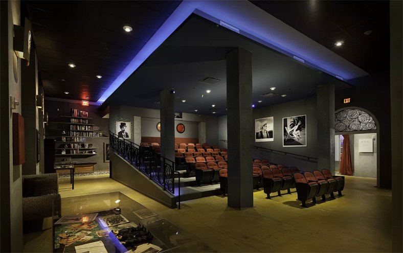 a small arthouse cinema with black-and-white film stills on the walls