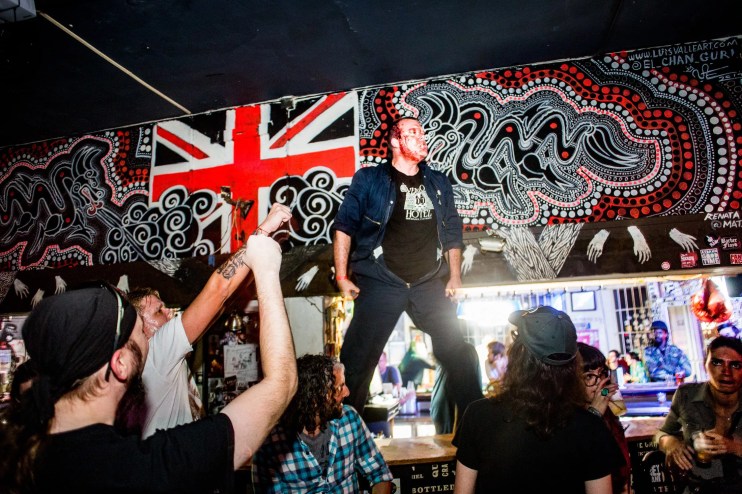 Picture of a band on stage with blood on their faces.