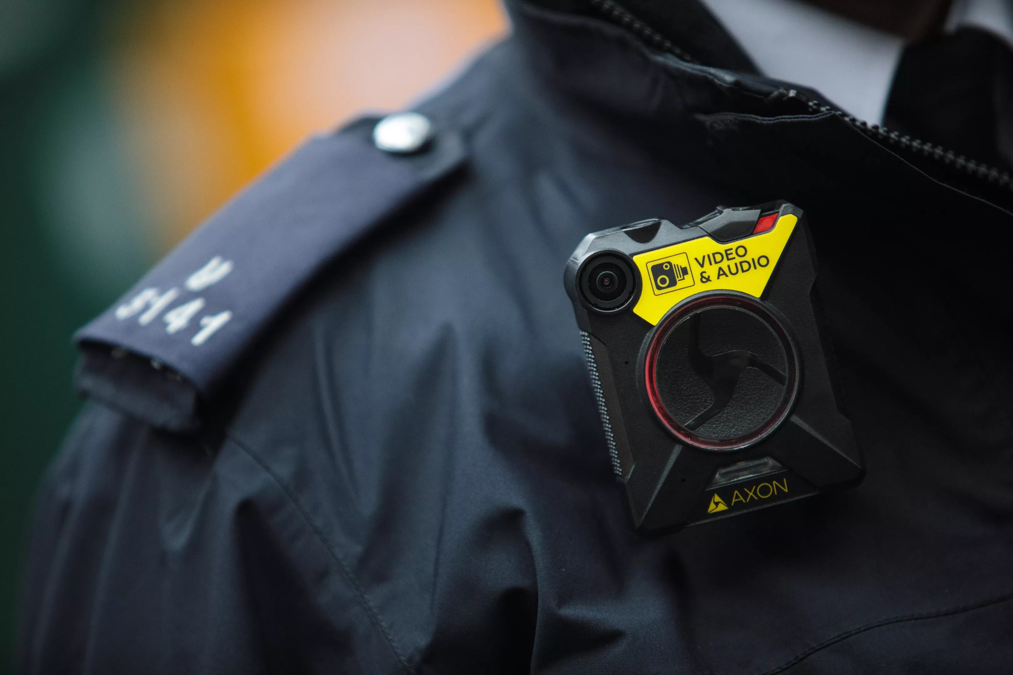 Image of a police officer's shirt and body-worn camera.
