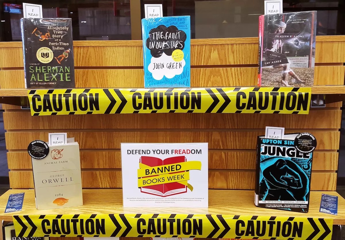 a bookstore display commemorating Banned Books week, featuring titles by Sherman Alexie, Jay Asher, John Greene, George Orwell, and Upton Sinclair