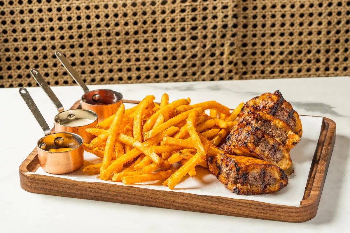 A burger with fries on a platter