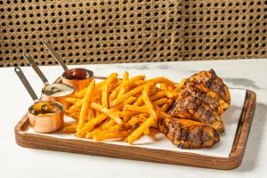 A burger with fries on a platter