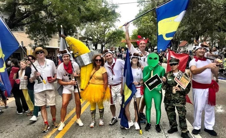 Participants in the King Mango Strut Parade in Coconut Grove line the street in costume