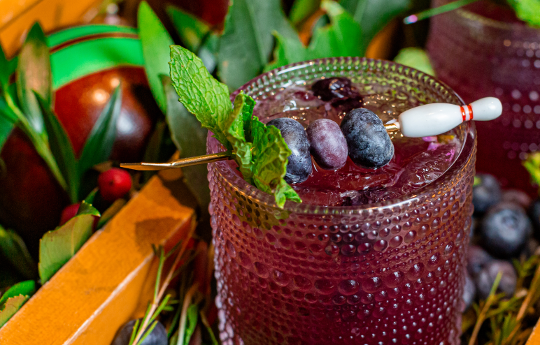 A purple blueberry cocktail at Pinstripes Aventura