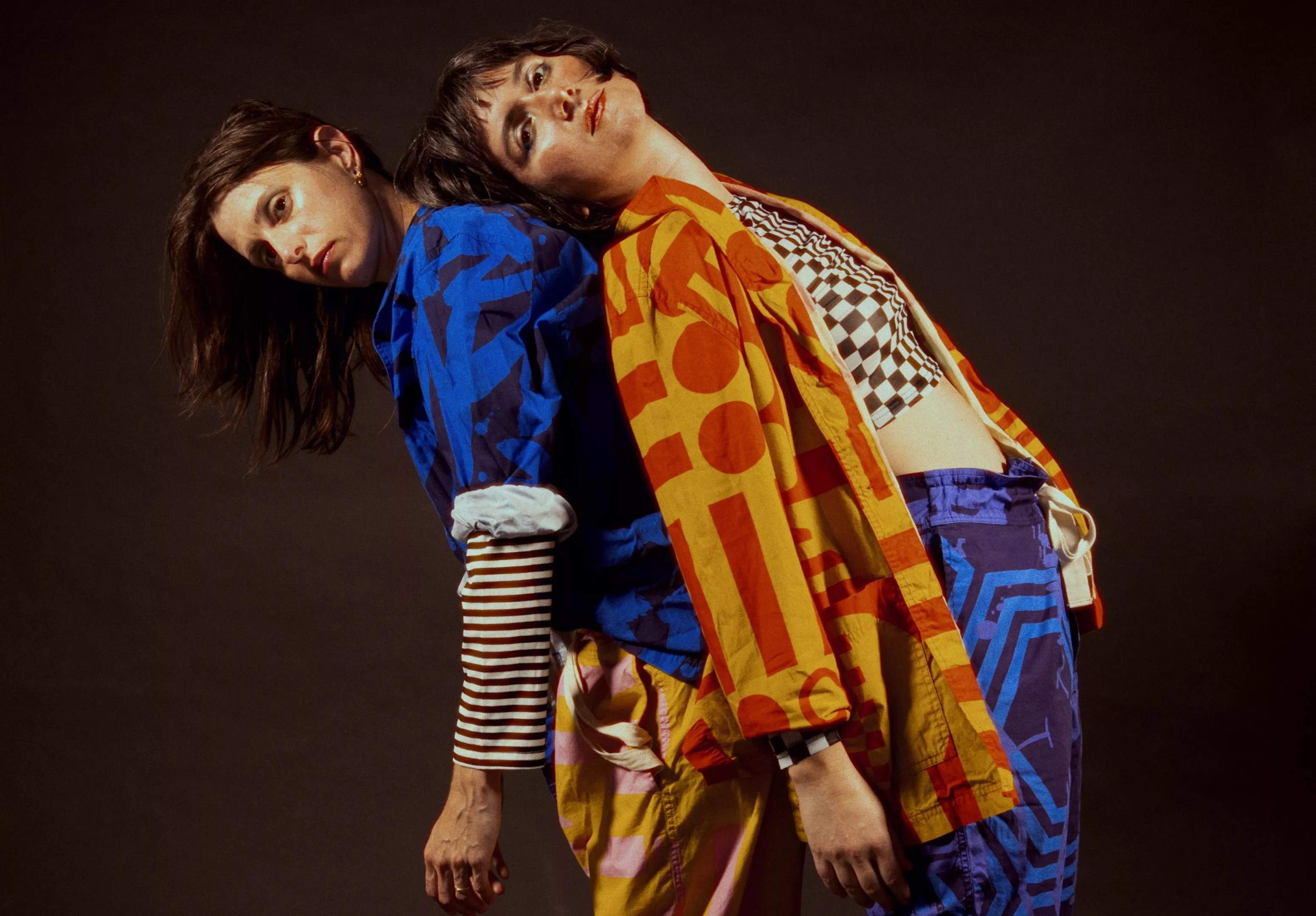 Emile Milgrim and Ale Campos of Las Nubes stand back to back