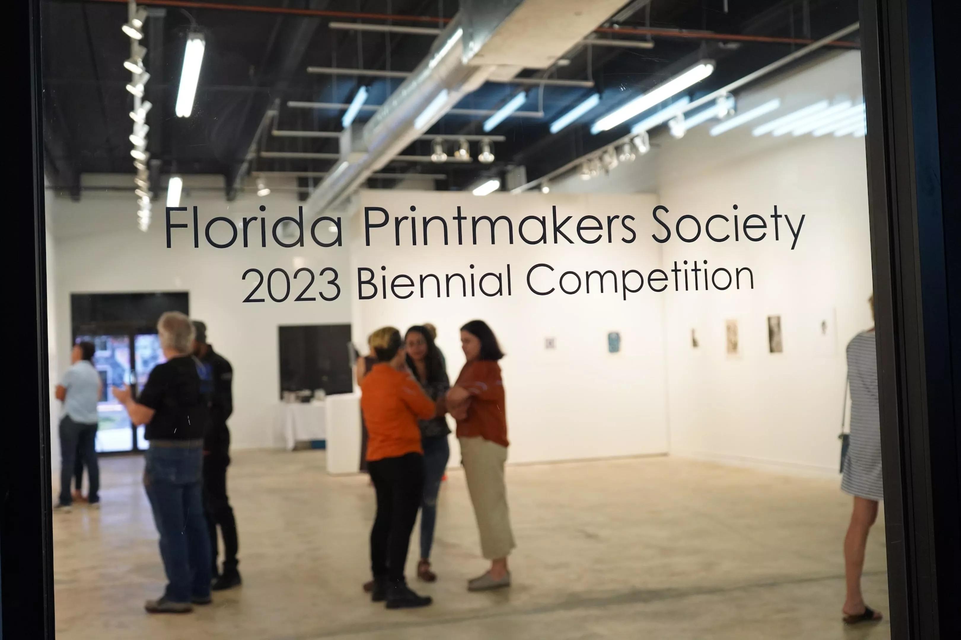 Glass door with the words Florida Printmakers Society 2023 Biennial Competition inscribed on it