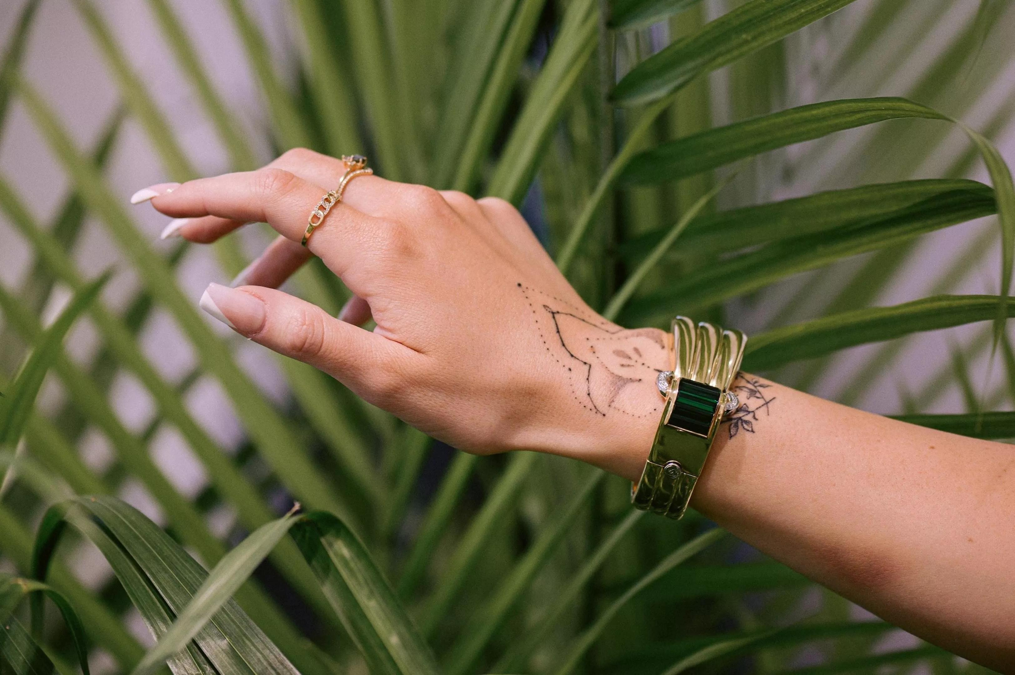 A hand models an ornate bracelet