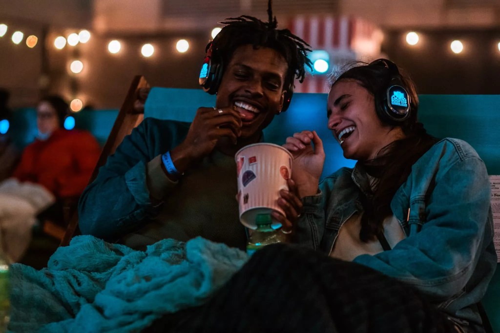 A couple enjoys a bucket of popcorn