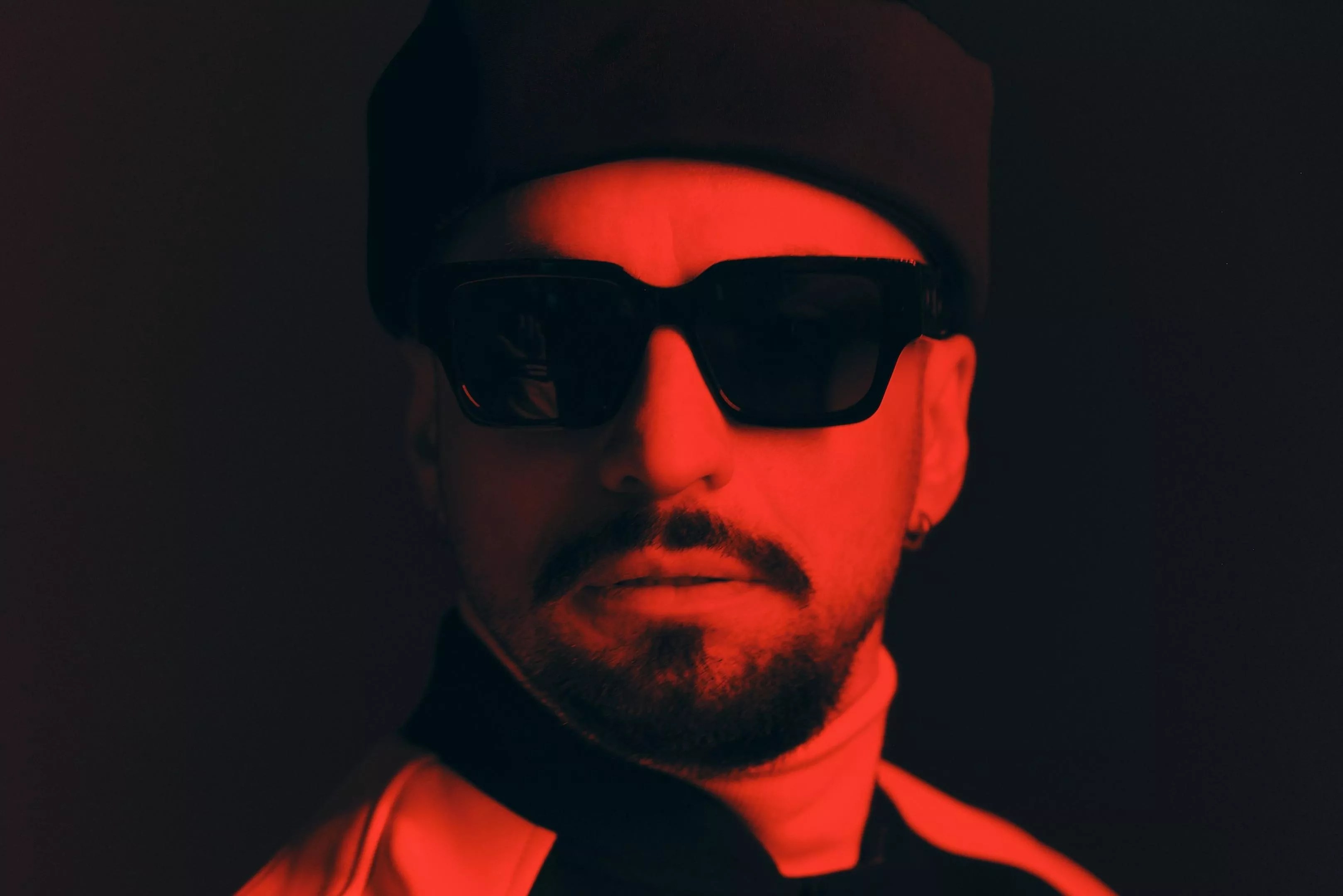 Portrait of producer Dombresky bathed in a red light