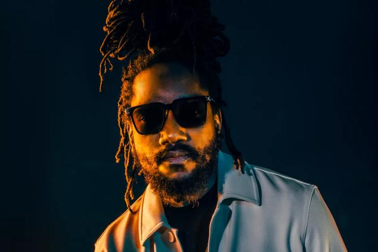 headshot of kabaka pyramid in a jean jacket