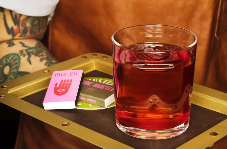 Negroni in a glass next to matches