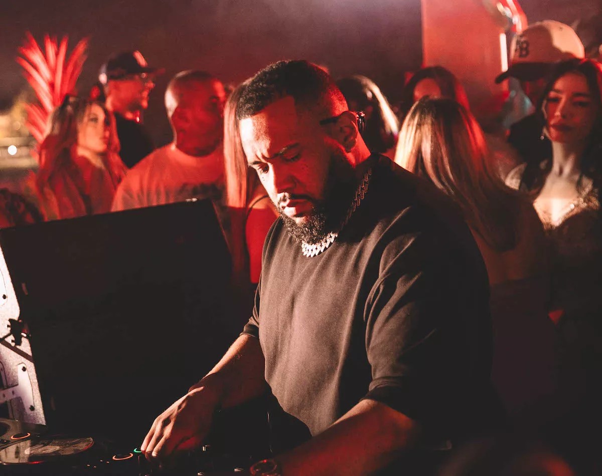 Gordo spinning at the festival with a crowd of people behind him.