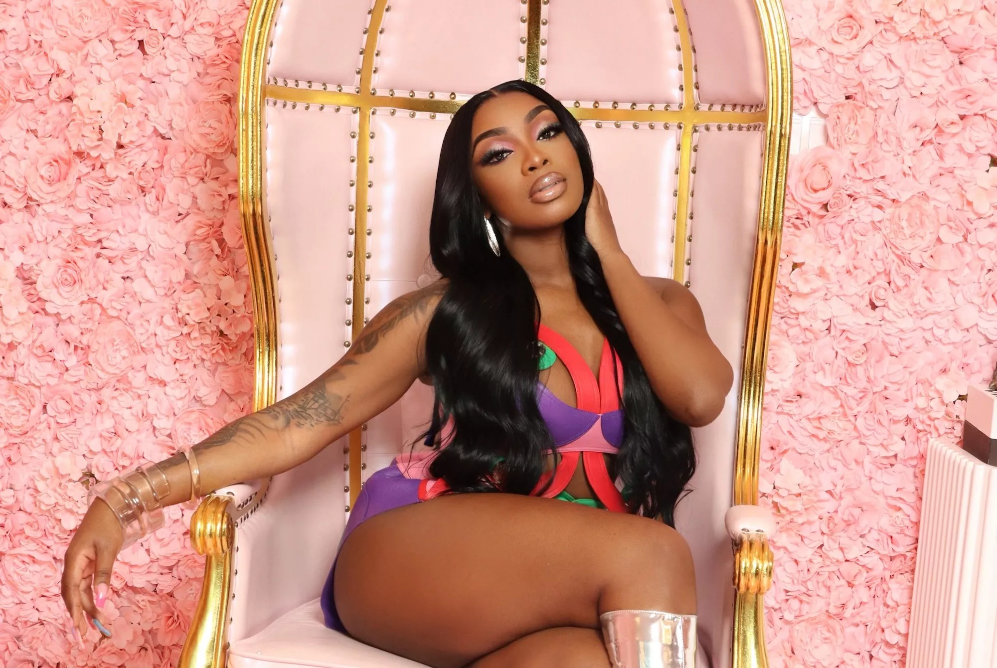 iCandy sitting in a pink chair