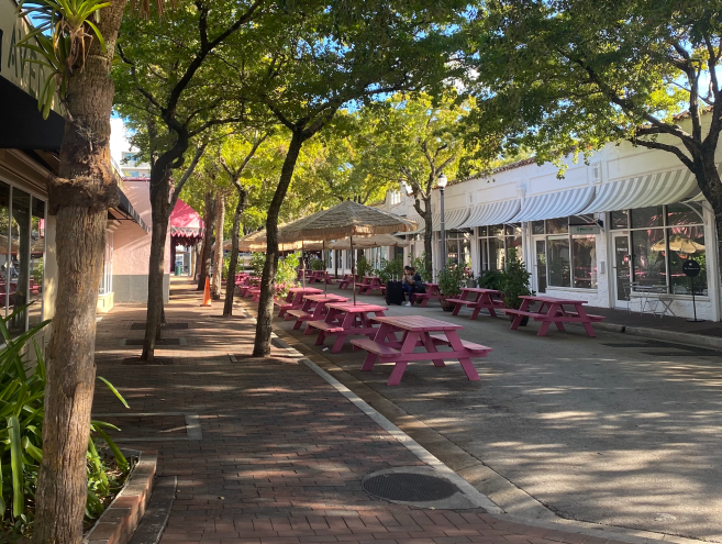 An empty street with pink picnic seating
