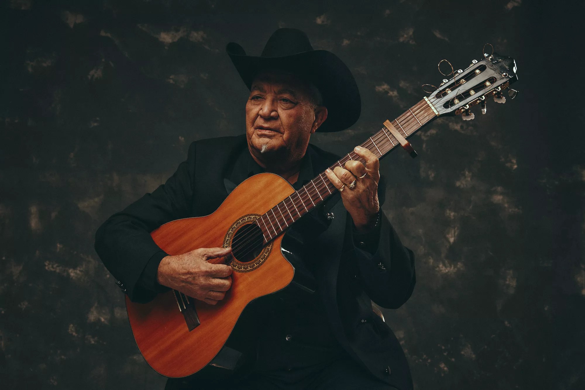 Eliades Ochoa strumming a guitar