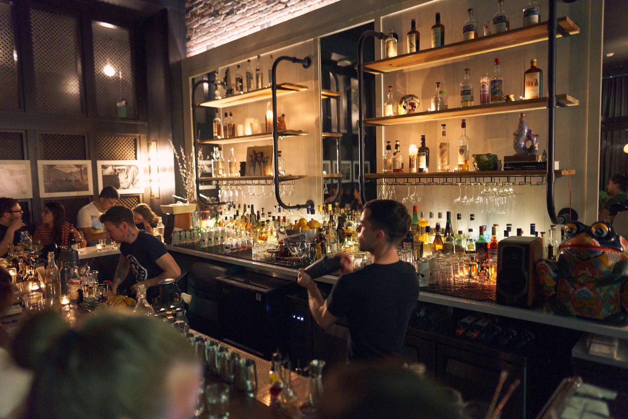 a well appointed bar with well trained bartenders making cocktails