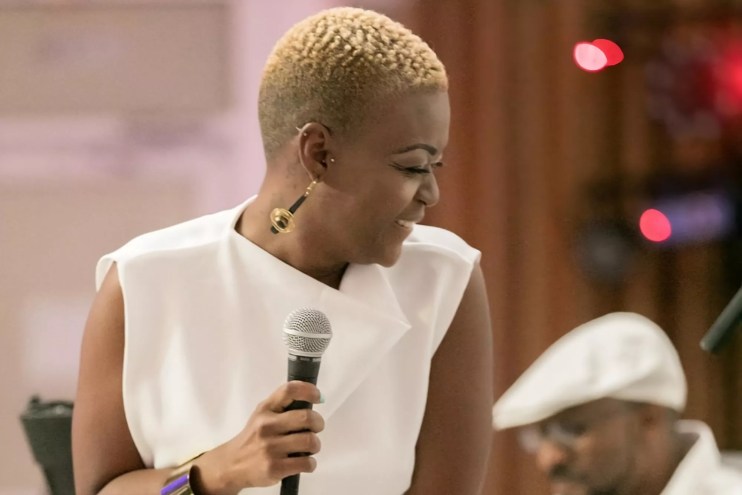 LaVie holding a microphone while performing onstage