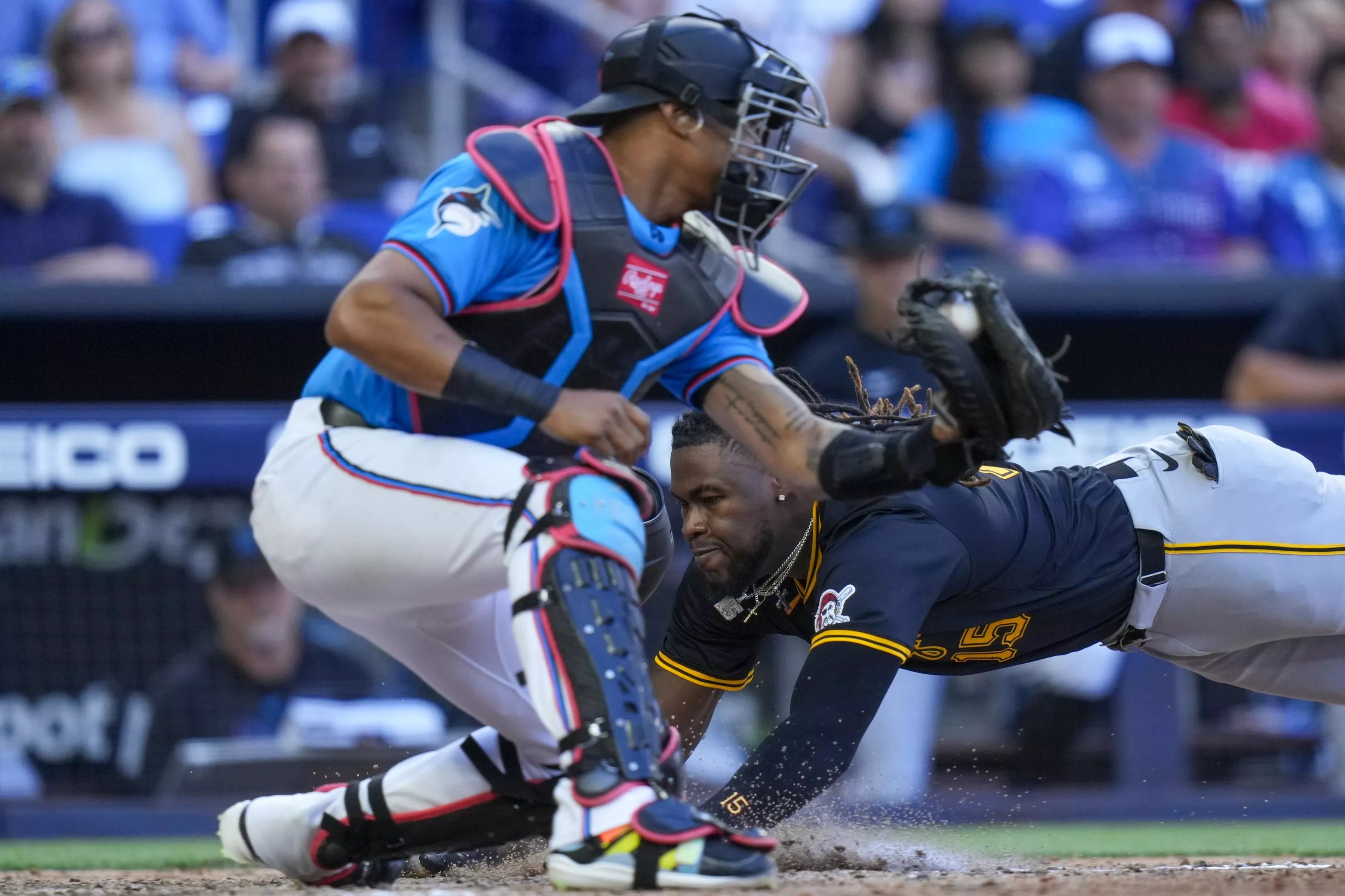 A Pittsburgh Pirates player slides into home base during extra innings.