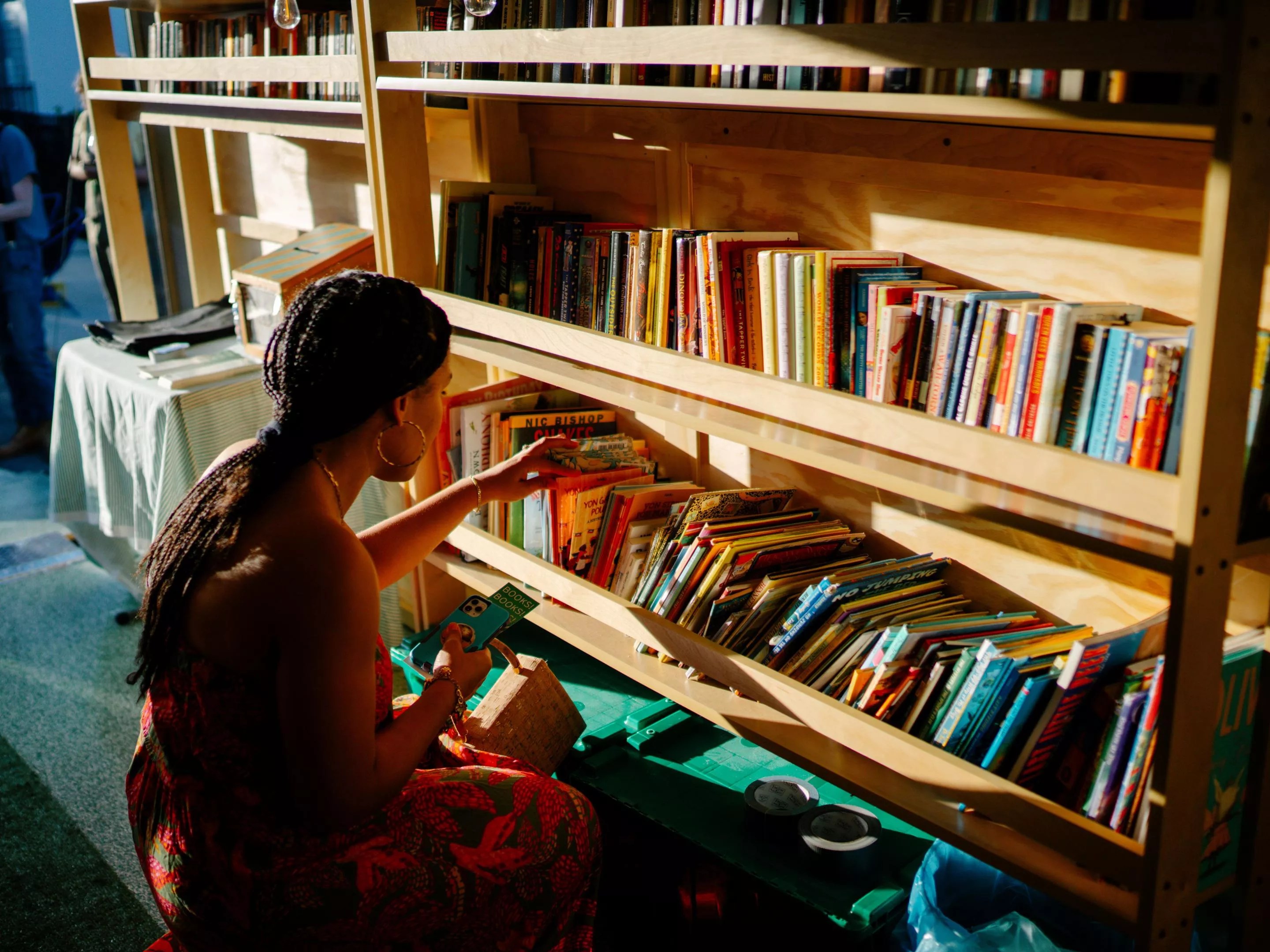 A woman browsing the shelves of the Bookleggers book trailer