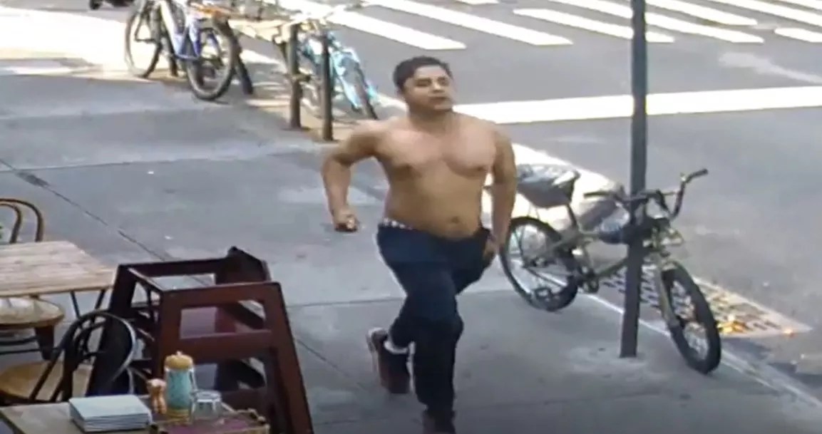 A shirtless man runs desperately through the streets of New York City