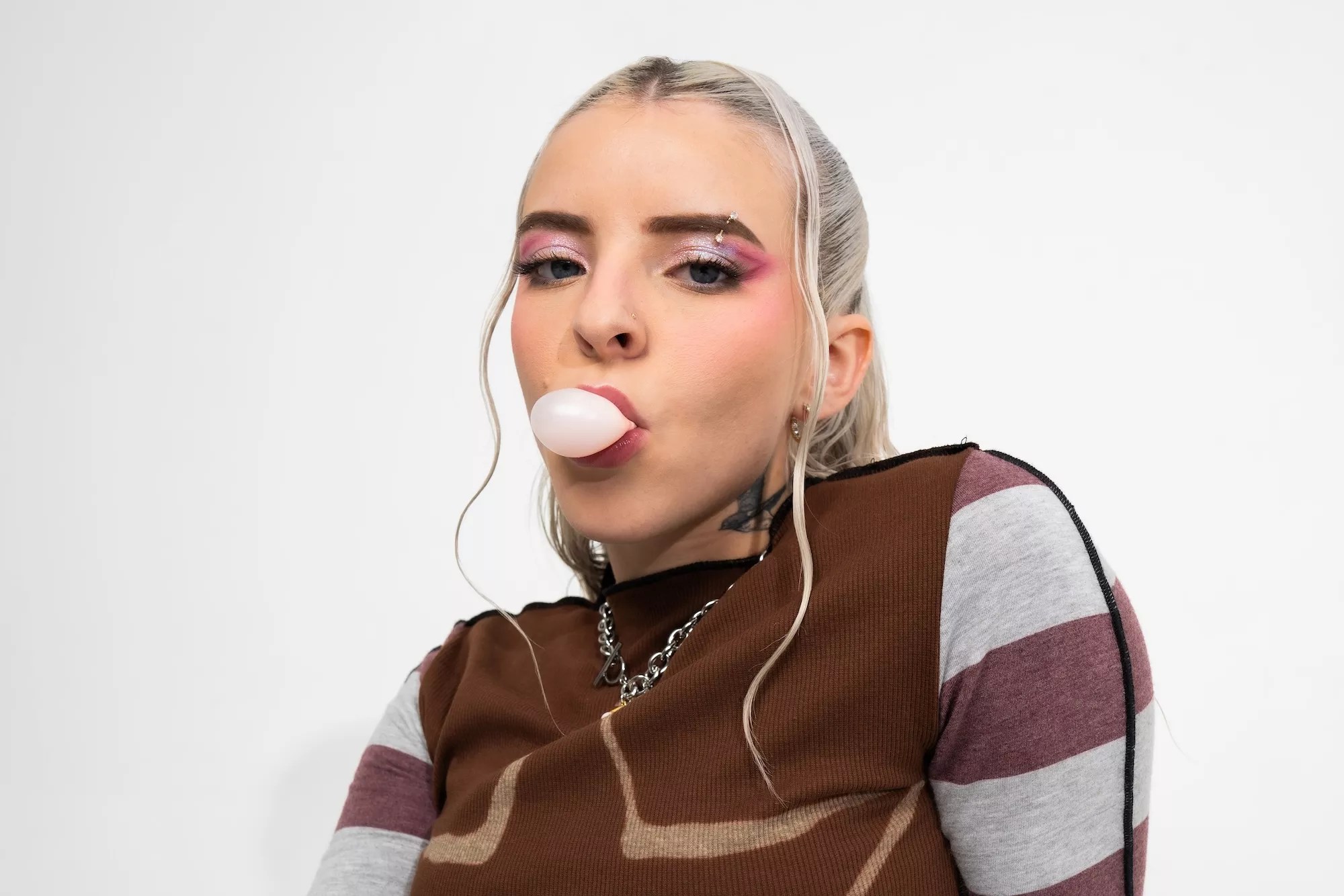 Portrait of Young Miko blowing a bubble from her gum