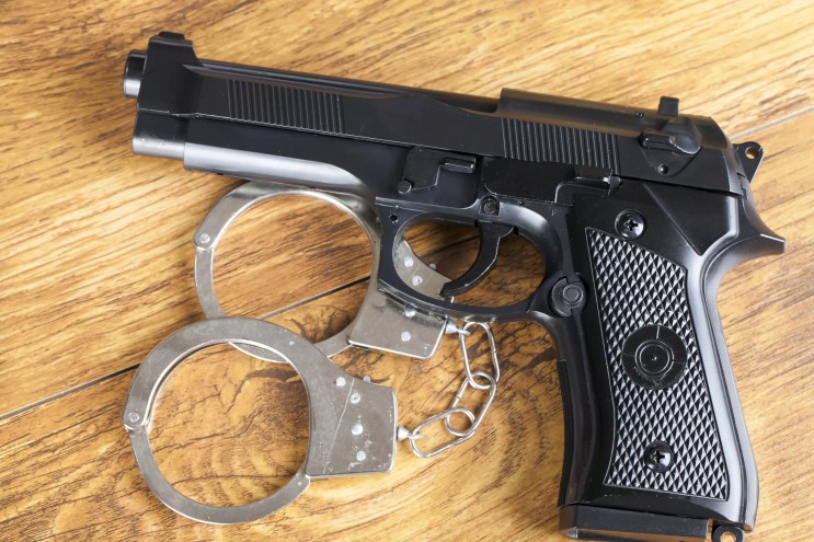 Stock photo of a gun and handcuffs