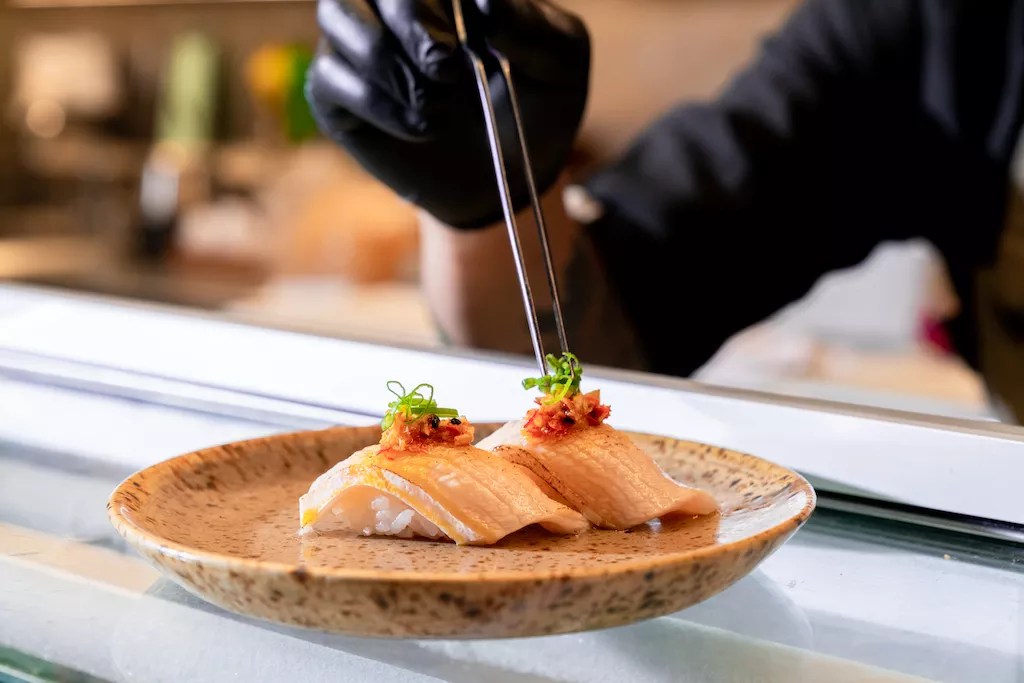 Two pieces of nigiri on a white plate