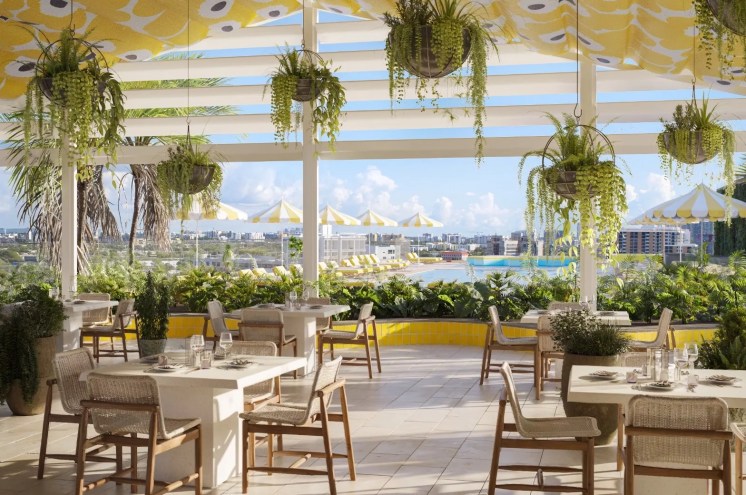 A lush pool area and dining space with greenery