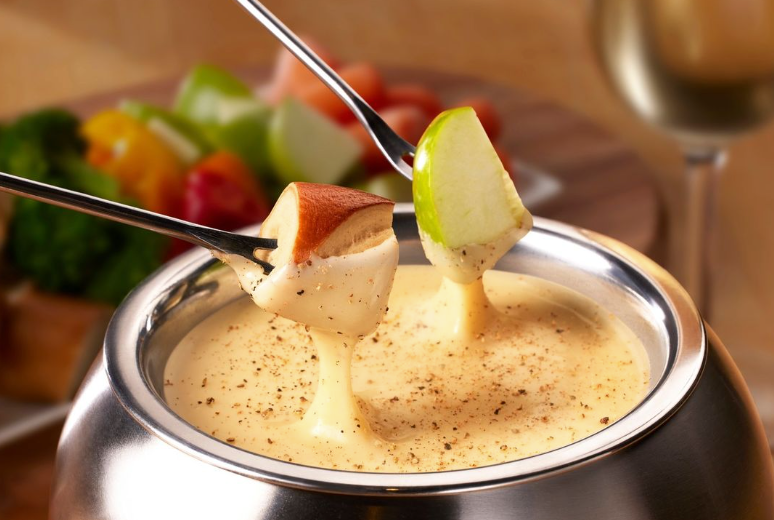 Two pieces of apples dipped in cheese