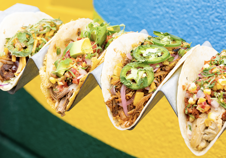 A row of colorful tacos