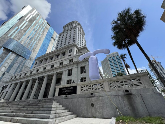 A large grey balloon in the shape of an intrauterine outside a Miami courthouse building