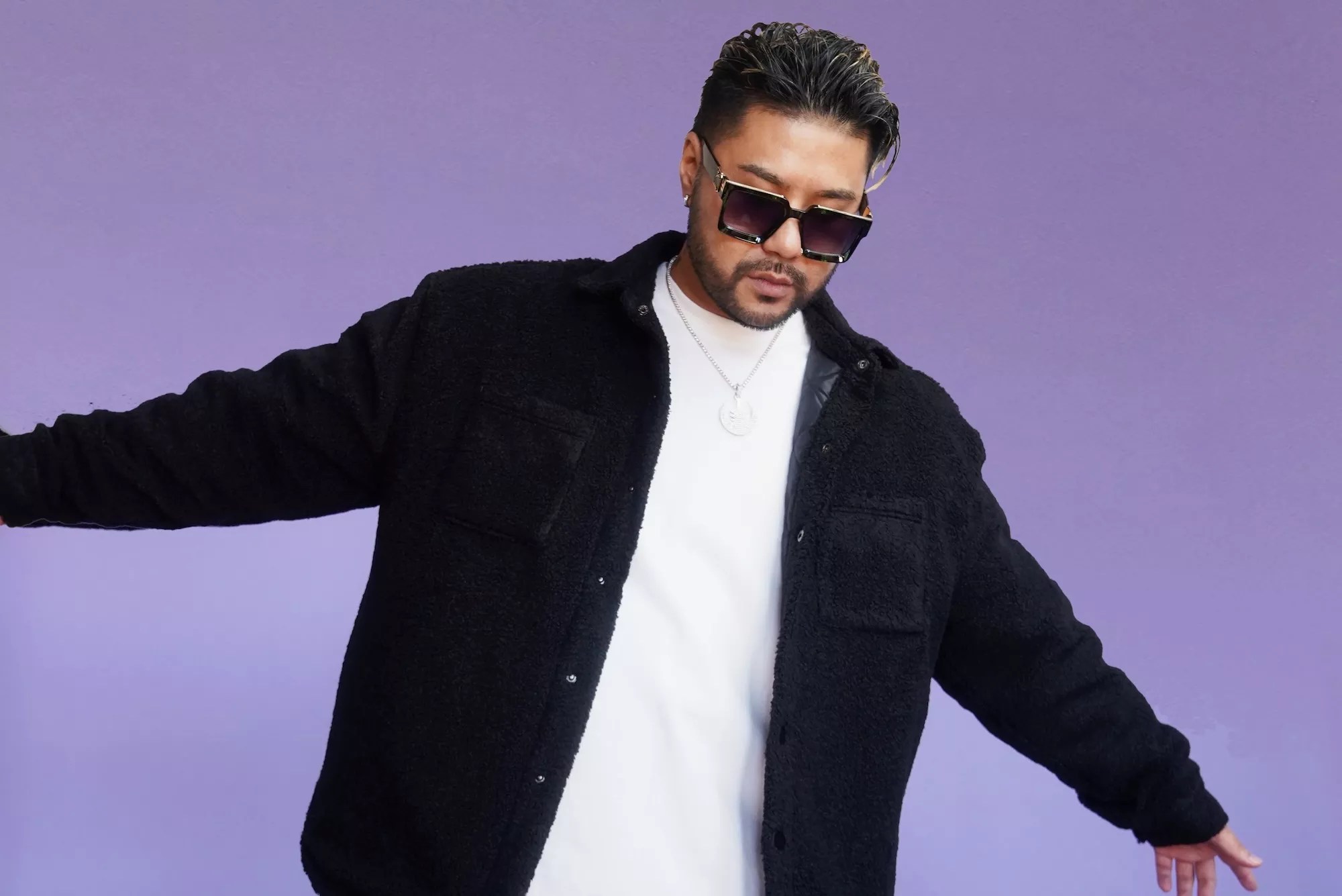 Portrait of Wax Motif against a purple background