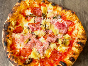 a close up of a pizza with toppings