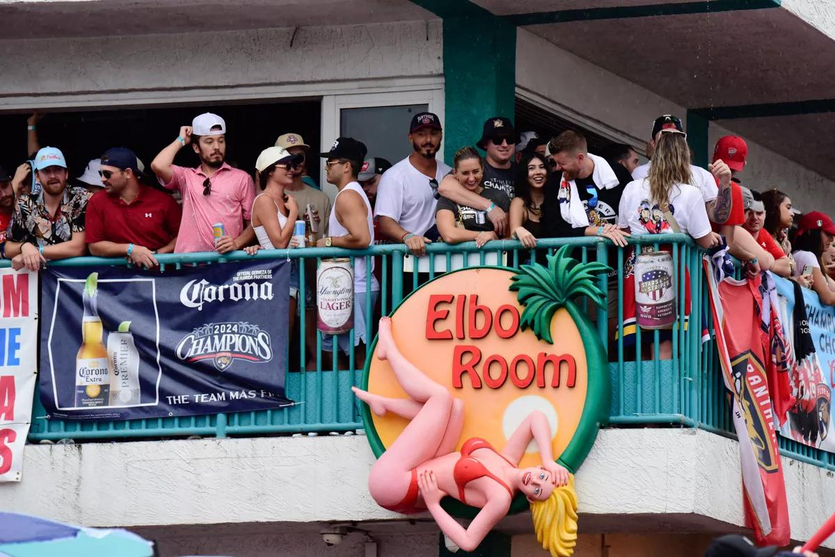 Florida Panthers fans stand alongside the second-story railing at Elbo Room in Fort Lauderdale during the 2024 parade