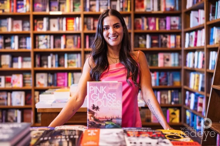 Asha Elias poses with her book
